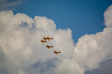airplane flying in the sky with clouds