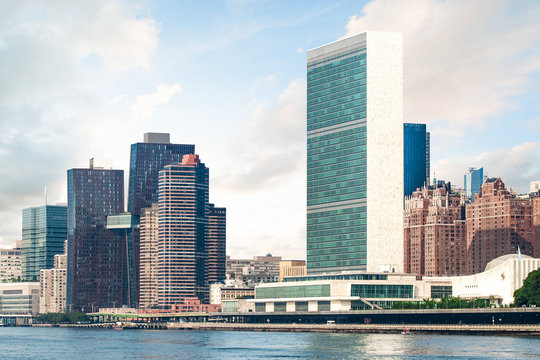 View of Midtown Manhattan skyline and the United Nations headquarters, viewed from Roosevelt Island over the East River during sunny summer day