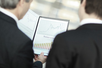 rear view.closeup of business partners discussing financial documents