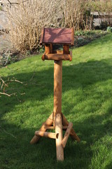 a wooden birdhouse at the lawn closeup in winter