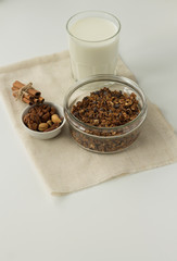 homemade baked muesli and milk on white background, top view, horizontal