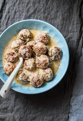 Cream sauce fried meatballs on grey background, top view