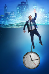 Businessman in deadline and time management concept