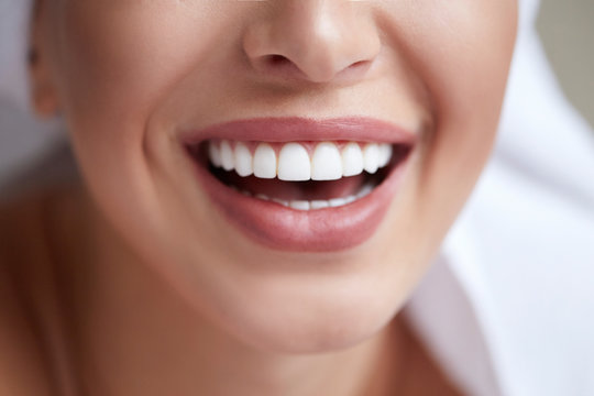 Healthy white smile close up. Beauty woman with perfect smile, lips and teeth. Beautiful Girl with perfect skin. Teeth whitening