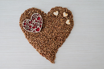 Roasted buckwheat heart on a background of heart-shaped buckwheat. Gluten free and healthy diet. I love the concept of buckwheat. copyright.
