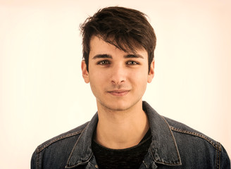 Close-up of handsome young man or teenager in studio, isolated on white background