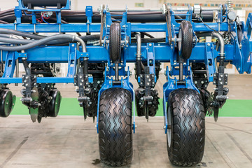 Part of the new agricultural technology. Corn harvester head with several silver blades. Agricultural machinery for soil cultivation.