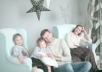 happy family sitting in the living room Christmas evening.