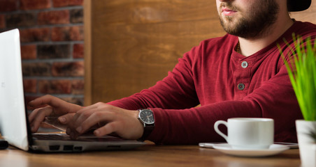 young handsome freelance artist in cafe or office