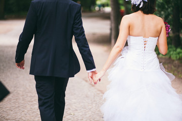 Hochzeitspaar von hinten mit haltenden Händen
