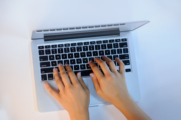 Fototapeta na wymiar female hands on a opened laptop