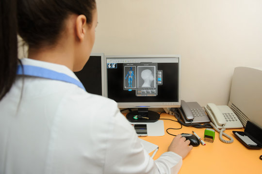 Young radiologist doctor edit and analyzes the digital  x ray on the computer