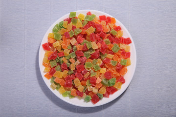 Pineapple slices on the plate. Four colours. Candied fruit.