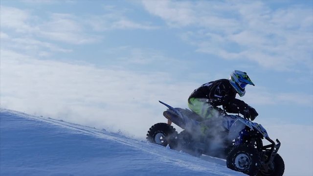 Concept of sports, healthy recreation. Quad Biking in the snow.