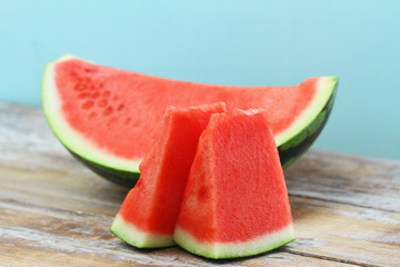 Slices of sweet and fresh watermelon on wooden surface
