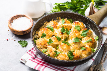 Meatballs in cream sauce with parmesan cheese.