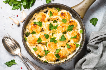 Meatballs in cream sauce with parmesan cheese top view.