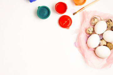 Chicken and quail eggs nest and paint on white background happy easter craft concept