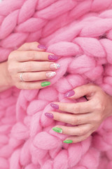 lots of color gloss manicure hands has different blotches in pink background