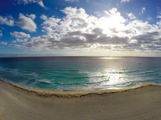 Playa Delfines, Cancun, Mexico. Aerial view on beach and coast of Caribbean sea against blue sky. Top view