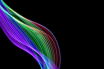 Abstract lines made with light painting with the colors of the rainbow on black background