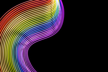 Abstract lines made with light painting with the colors of the rainbow on black background