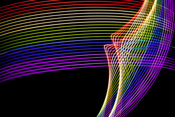 Abstract lines made with light painting with the colors of the rainbow on black background
