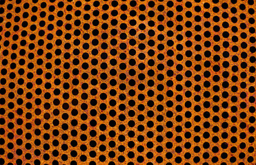 Perforated rusty  iron sheet texture. Surface of industrial mesh. Horizontal corrosion steel background. Top view