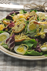 Healthy salad with quail eggs, grated cheese and crackers. Keto diet. Keto lunch