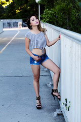 Asian American Woman Standing In Shorts And Top Outdoors