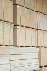 timber in warehouse. Pallet with boards in the hardware store. Packed boards in the building store. building materials. warehouse with variety of timber for construction and repair. vertical photo.