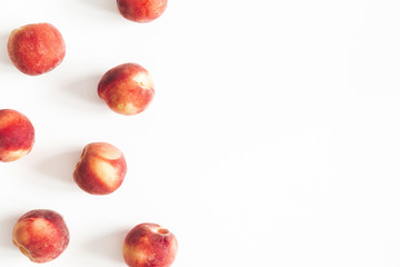 Peaches on white background. Frame made of fresh peaches. Flat lay, top view, copy space