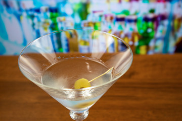 Dry martini cocktail with olive on toothpick