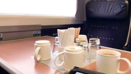 Using an Ipad to write a business report in a first class train carriage on the way to London, England.