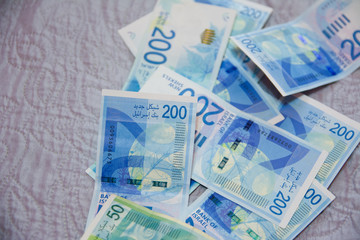 Israeli money stack of the new Israeli money bills banknotes of 200 and 50 shekel. New Israeli Shekel series C.