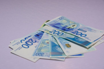 Israeli money stack of the new Israeli money bills banknotes of 200 and 50 shekel. New Israeli Shekel series C.