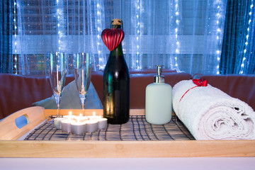 Romantic composition with two glasses for wine and candles. St.Valentine’s Day background. Spa. Selective focus low light.