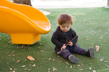 Little infunt cute boy playing on playground.