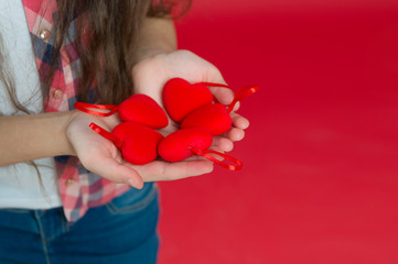 Love is a great feeling. Valentines day. Small girl with hearts in hands. happy little girl. Love and family. Childhood happiness. February holiday. Childrens day. Happy child with heart. copy space