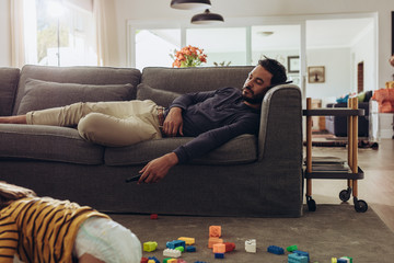 Man sleeping on couch at home