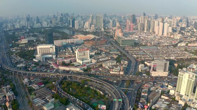 Bangkok central business downtown, heavy traffic aerial view. Top view of Thailand's capital. Big city life, transportation, infrustructure and developing country concept.