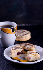 Delicious desserts on a black background. Cookies and marshmallows on the background. Fragrant dessert.