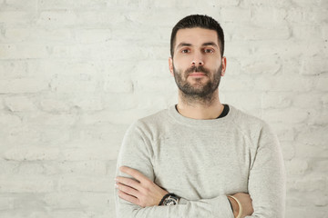 Portrait of handsome bearded man in a grey pullover 