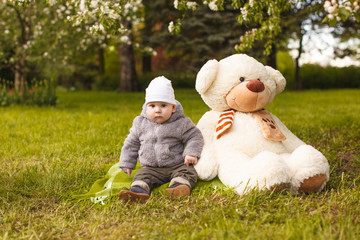 Baby in the park in the rays of sunset. Toddler on the nature outdoors. Backlight. Summertime family  scene