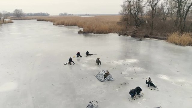 Aerial View Of River, Fishermen on Ice. Cloudy Winter Day. Energodar, Ukraine. 4K video
