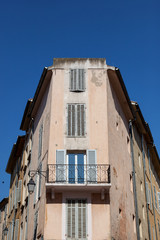 Narrow building with shuttered window and balcony in Aix-en-Provence, France