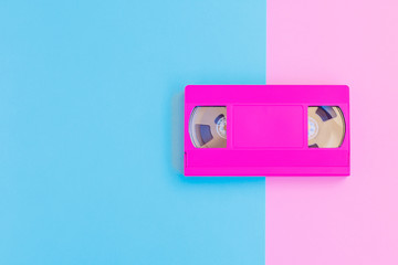 VHS cassette on soft pink and blue paper background. Minimal concept. Creative concept. Cinema concept. Pop Art. Bright Sweet fashion Style.