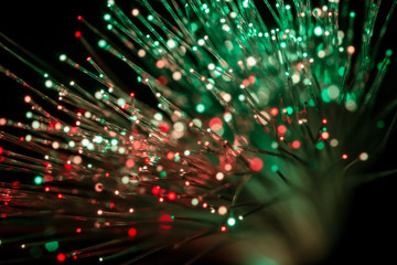 bundle of optic fibers in red and green light