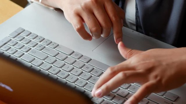 Woman's Hand Typing on Laptop
