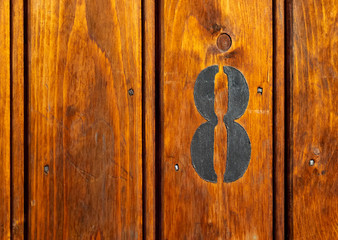 number 8 on door of storage room for tenants in century-old apartment building in stockholm